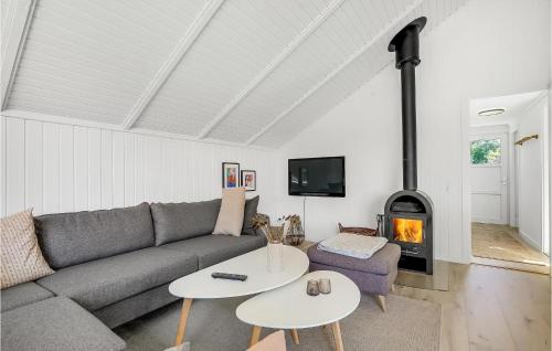 a living room with a couch and a fireplace at Holiday Home Blåvand Strand Blåvand X in Blåvand