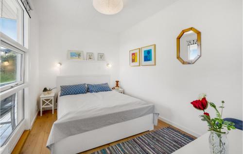 ein weißes Schlafzimmer mit einem Bett und einem Fenster in der Unterkunft Nice Home In Augustenborg With Sauna in Asserballeskov