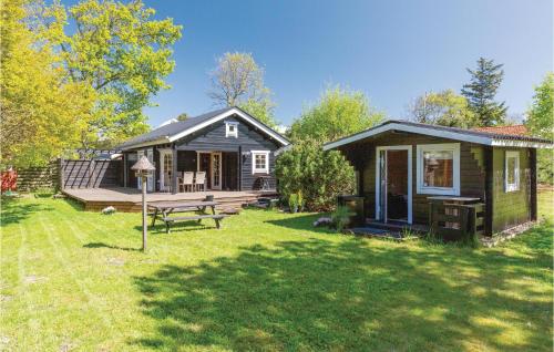 a small cabin with a picnic table in a yard at Lovely Home In Gørlev With Wifi in Gørlev