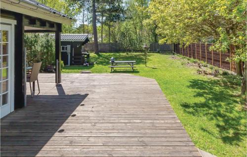 a wooden walkway with a bench in a yard at Lovely Home In Gørlev With Wifi in Gørlev