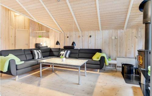 a living room with a couch and a table at Holiday Home Blomstervangen Denm I in Oksbøl