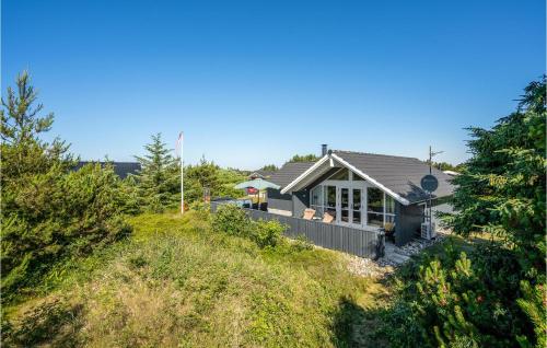 a house on the side of a hill at Holiday Home Kirksvej Hvide Sande Iv in Bjerregård