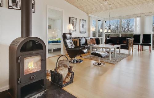 a living room with a wood stove in a living room at Awesome Home In Vinderup With Wifi in Vinderup