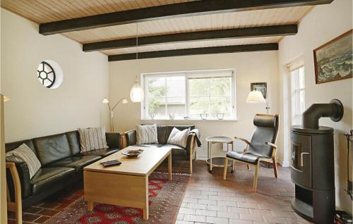 a living room with a couch and a table at Tefres in Snogebæk