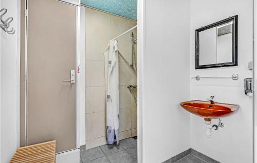 a bathroom with a red sink and a shower at 2 Bedroom Amazing Home In Roslev in Sallingsund