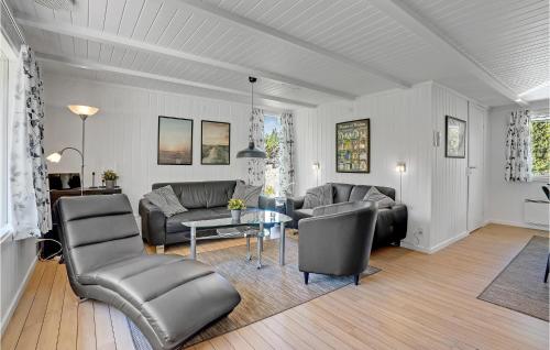 a living room with a couch and a table at Holiday Home Regnspoven Rømø Ix in Rømø Kirkeby