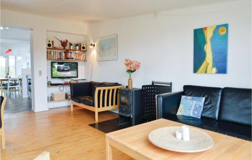 a living room with a couch and a table at Awesome Home In Hirtshals With Sauna in Hirtshals