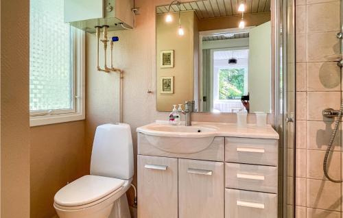 a bathroom with a toilet and a sink and a shower at 3 Bedroom Stunning Home In Aakirkeby in Vester Sømarken