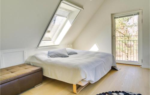 NeksøにあるStunning Home In Nex With 4 Bedrooms, Sauna And Wifiのベッドルーム1室(ベッド1台、窓2つ、ソファ付)