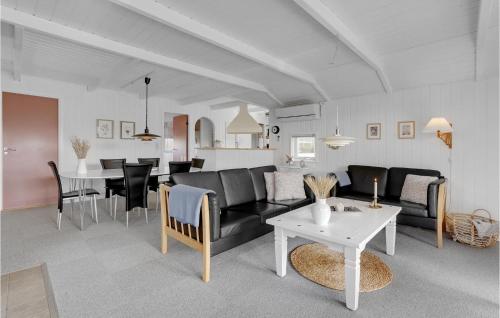a living room with a couch and a table at Holiday Home Blommevænget Hejls Vi in Hejls