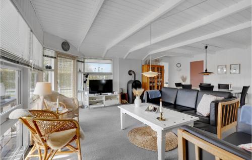 a living room with a couch and a table at Holiday Home Blommevænget Hejls Vi in Hejls