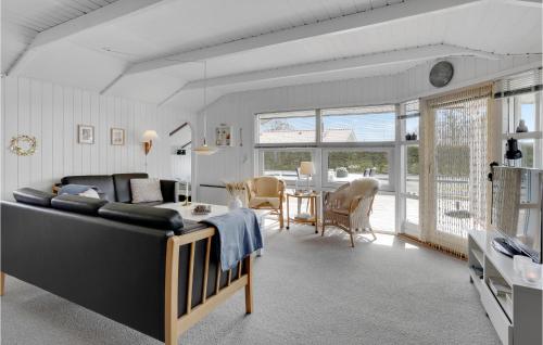 a living room with a couch and a dining room at Holiday Home Blommevænget Hejls Vi in Hejls