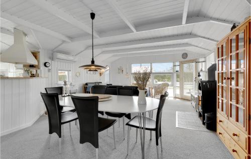 a kitchen and dining room with a table and chairs at Holiday Home Blommevænget Hejls Vi in Hejls