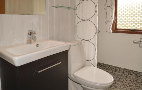 a bathroom with a white sink and a toilet at 2 Bedroom Cozy Home In Hemmet in Hemmet