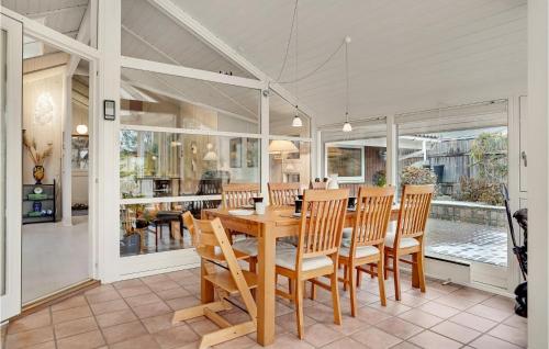 a dining room with a wooden table and chairs at 2 Bedroom Amazing Home In Slagelse in Slagelse