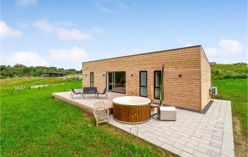 a small wooden house with a circular patio at Amazing Home In Spøttrup With Wifi in Lihme