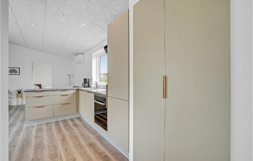 a kitchen with white cabinets and a window at Amazing Home In Spøttrup With Wifi in Lihme