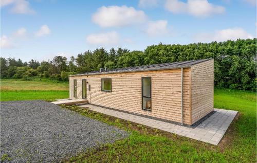 a small wooden cabin in a field with trees at Amazing Home In Spøttrup With Wifi in Lihme