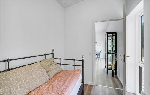 a bedroom with a bed and a hallway with a door at Amazing Home In Spøttrup With Wifi in Lihme