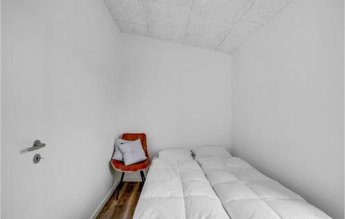 a bedroom with a white bed and a red chair at Amazing Home In Spøttrup With Wifi in Lihme