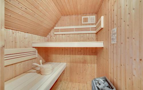 a wooden sauna with two bunk beds and a basket at Cozy Home In Humble With Sauna in Humble