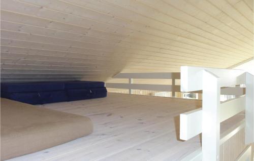 a bedroom with a bed and a wooden floor at Nice Home In Faaborg With Wifi in Bøjden