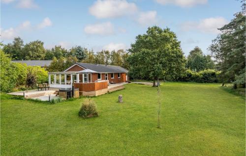 a house in a field with a large yard at 3 Bedroom Lovely Home In Havndal in Havndal
