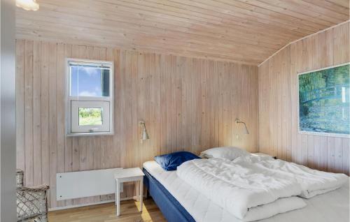 GrønhøjにあるPyntenの木製の壁に大きなベッドが備わるベッドルーム1室