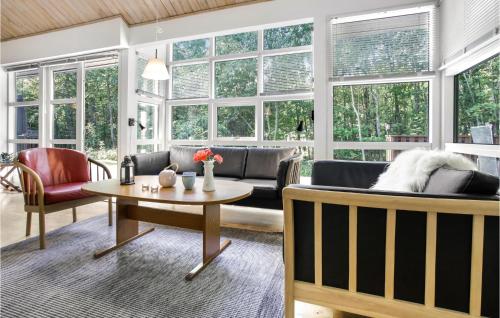 a living room with a couch and a table at Nice Home In Hasle With Wifi in Hasle