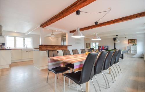 a kitchen and dining room with a wooden table and chairs at Nice Home In Skrbk With House A Panoramic View in Skærbæk
