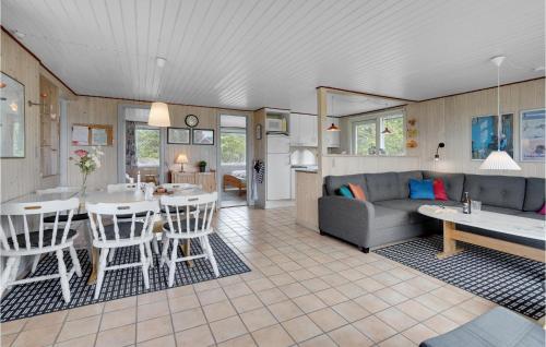 a living room with a couch and a table at Holiday Home Ringvejen Vi Denmark in Rømø