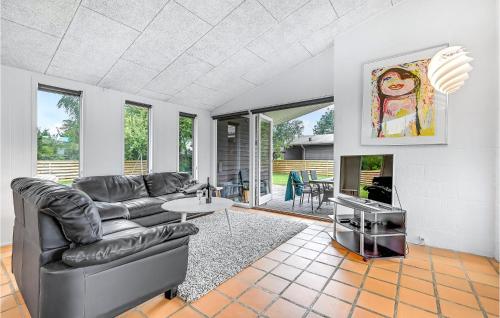 a living room with a couch and a table at Holiday Home Fjordvej Børkop Ix in Egeskov