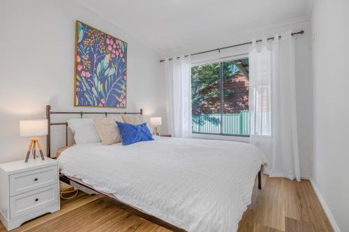 a bedroom with a large bed and a window at Pine View Cottage in Bright