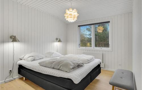a bedroom with a large bed in a room with a window at Amazing Home In Jgerspris With Wifi And 2 Bedrooms in Jægerspris