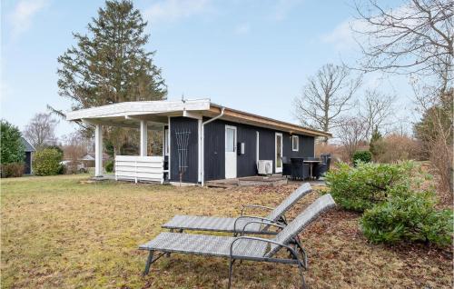 a bench sitting in front of a small house at Holiday Home Jægerspris With Fireplace Iii in Jægerspris