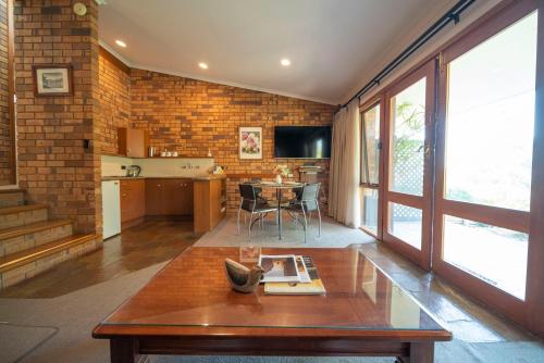 a living room with a table and a kitchen at Blickinstal Holiday Retreat in Bethany