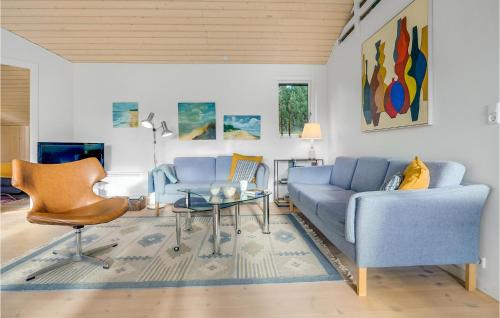 a living room with a couch and a table at Three-Bedroom Holiday Home In Vaggerlose in Marielyst