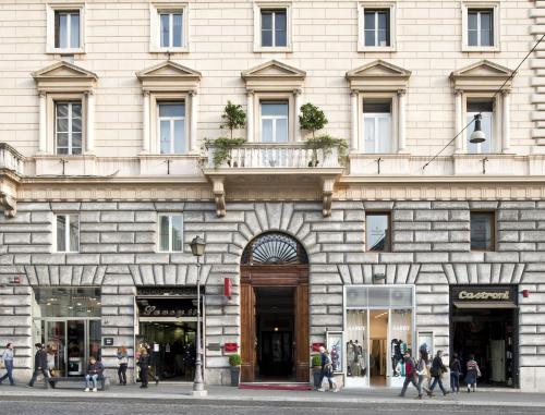 a building with people walking in front of it at Vibe Nazionale in Rome