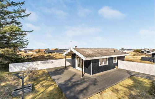 a black and white house with a wooden deck at 2 Bedroom Beautiful Home In Thisted in Thisted