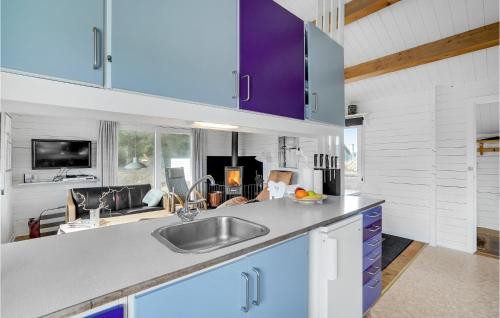 a kitchen with purple cabinets and a sink at 2 Bedroom Beautiful Home In Thisted in Thisted