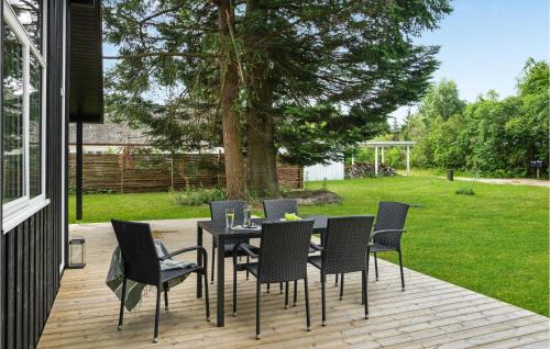 a patio with a table and chairs on a deck at Beautiful Home In Højby With Wifi in Højby