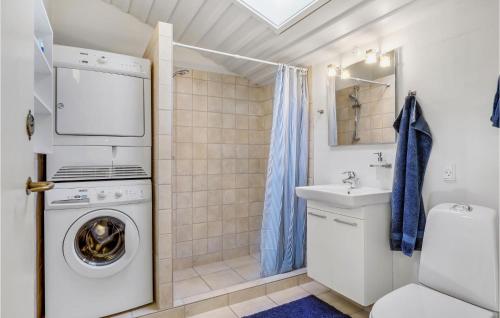 a bathroom with a washing machine and a sink at Lovely Apartment In Allinge With Wifi in Allinge