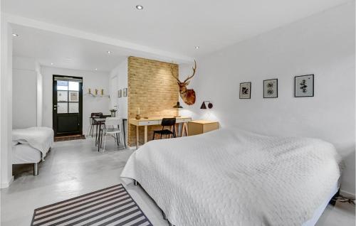 a white bedroom with a bed and a desk at Amazing Home In Engesvang in Engesvang