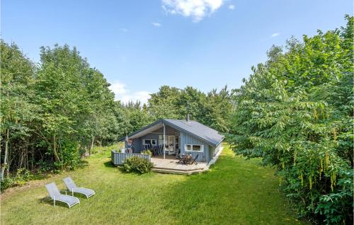 a tiny house in the middle of a yard at Four-Bedroom Holiday Home In Dronningmolle in Dronningmølle