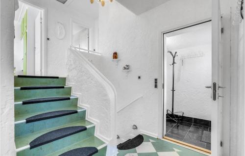 a staircase in a house with blue and green floors at Awesome Home In Hvide Sande With Wifi in Hvide Sande