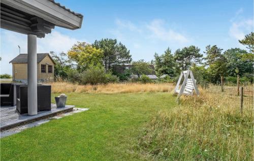 a backyard with a yard with a swing at Nice Home In Gørlev With House Sea View in Gørlev