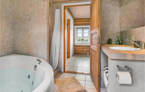 a bathroom with a tub and a sink at Nice Home In Grlev With House Sea View in Gørlev