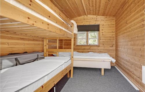 a log cabin with two beds in it at Stunning Home In Ørsted With Kitchen in Ørsted