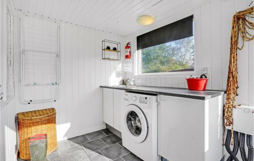 a white laundry room with a washing machine at Stunning Home In Ørsted With Kitchen in Ørsted