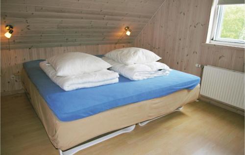 LohalsにあるAmazing Home In Tranekr With 5 Bedrooms, Sauna And Wifiのベッド1台(枕2つ付)